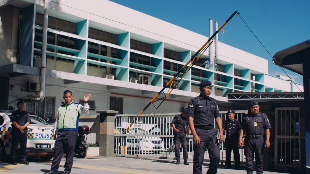 Police officers guard the entrance of the forensic department of Kuala Lumpur General Hospital on Wednesday.