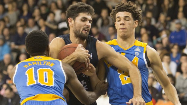 Melbourne United's Todd Blanchfield fights for the ball with UCLA's Isaac Hamilton and Lonzo Ball on Saturday night.