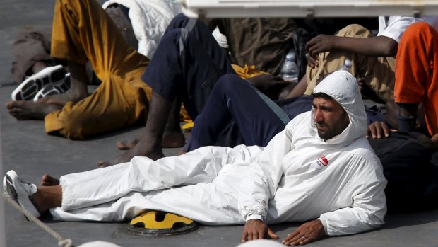 Mohammed Ali Malek, captain of a boat carrying migrants that capsized in the Mediterranean, watches as bodies are brought to land. He was later arrested. 