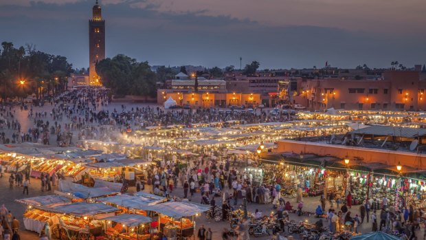 Everyone is out and about in Marrakech's Djemma El Fna Square by night.