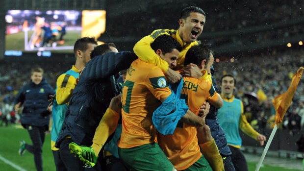 Australia's players celebrate a goal scored by Josh Kennedy (right) against Iraq during the World Cup Asian Qualifying match in 2013.