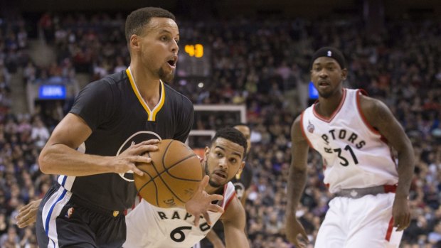 Unstoppable: Golden State Warriors star Stephen Curry drives past Toronto Raptors guard Cory Joseph.