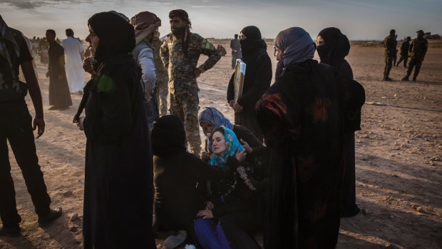 A woman grieves after the funeral of her brother, Omar al-Abed, a Syrian Democratic Forces militiaman who died fighting to oust Islamic State from Raqqa.