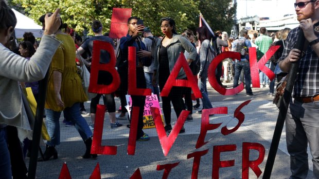 Demonstrators hold a "Black Lives Matter" banner while participating during the March for Racial Justice in the Brooklyn borough of New York on Sunday.