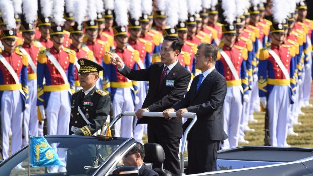 South Korean President Moon Jae-in, right, and Defence Minister Song Young-moo, centre, review the troops on Thursday ahead of South Korea's Armed Forces Day on Sunday.