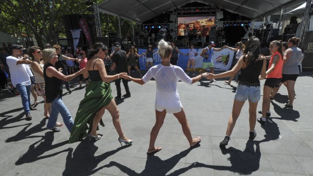 People get into the swing of the festival with Greek dancing in front of the Greek Glendi stage in Garema Place.

