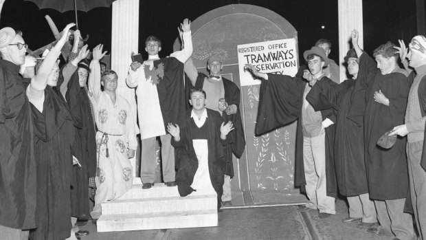 University students hold up the last Dulwich Hill tram on City Road on 28 September 1957. 