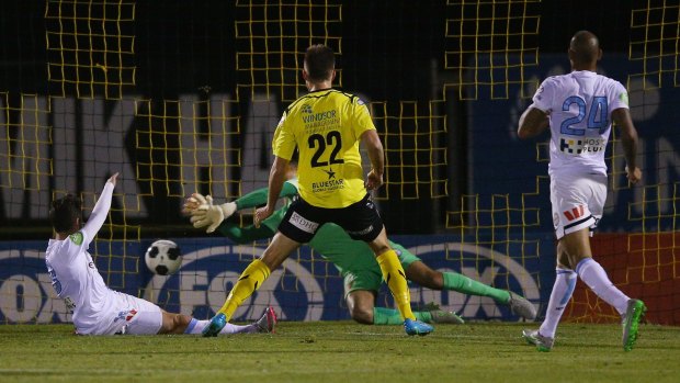 Kaine Sheppard of Heidelberg United (22) has his shot at goal stopped by City goalkeeper Tando Velaphi.