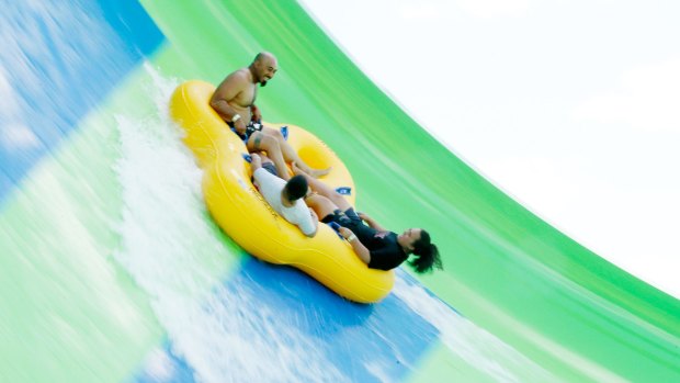 Thrillseekers ride the Gravity Wave water slide at Funfields theme park in Whittlesea on Tuesday.
