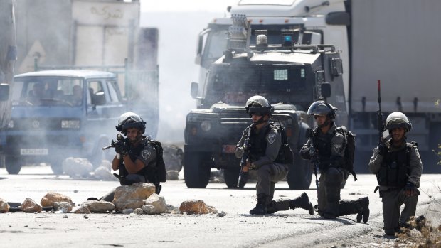 Israeli border policemen take positions during clashes with Palestinians at the Hawara checkpoint, near the occupied West Bank city of Nablus.