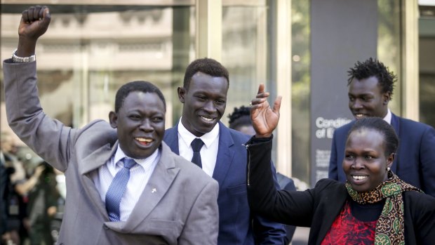 Majak Daw outside court with his father William and mother Elizabeth. William Daw crossed himself and cried "hallelujah" as he led his son out of the court building.