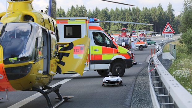 Rescue workers and firefighters wait to treat the injured.