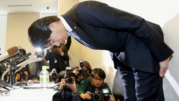 Japanese lawmaker Kensuke Miyazaki, of ruling Liberal Democratic Party, bows during a news conference in Tokyo in which he announced he would resign. 