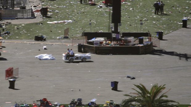 The day after the shooting, bodies remained on the ground, covered by sheets.