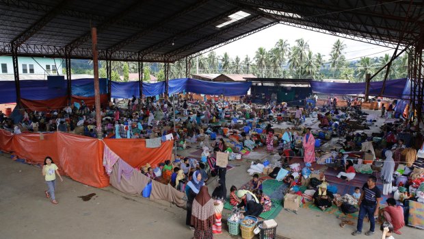 Displaced residents stay at an evacuation centre outside Marawi as it's unclear how many people remain trapped in the city.