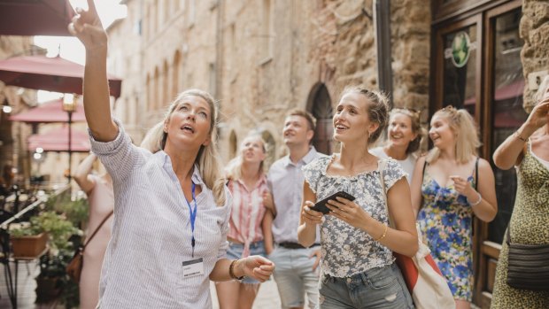It'll be a while before Australians can return to Italy. Pictured, a local guide shows tourists around Volterra, Italy.