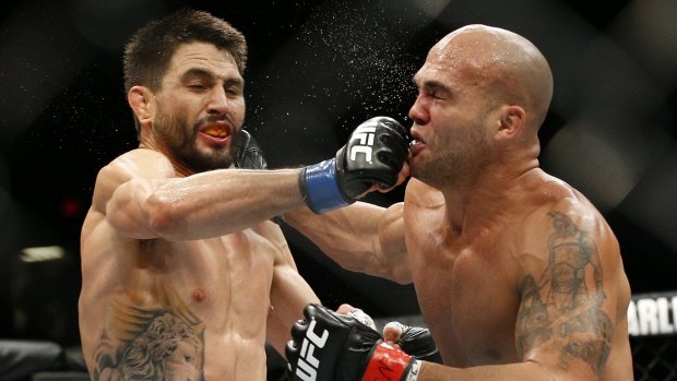 Robbie Lawler, right, trades blows with Carlos Condit in the UFC 195 welterweight championship bout in Las Vegas.