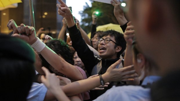 Pro-democracy activists are blocked by policewomen as they shout slogans at a rally in Hong Kong on Wednesday. 