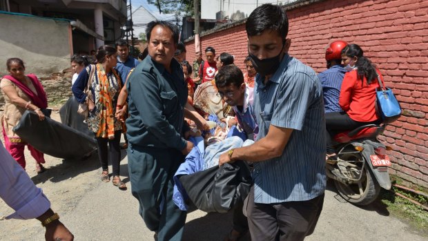 Nepalese patients are carried out of a Kathmandu hospital building as an earthquake hits the country on May 12.   