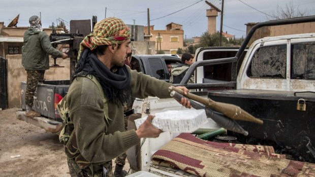 YPG fighters prepare their weapons in Tel Jumaa.