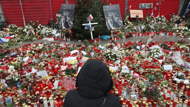 A visitor looks at a memorial to victims of the December 19 terror attack at a Chrismas market in Berlin, Germany. 