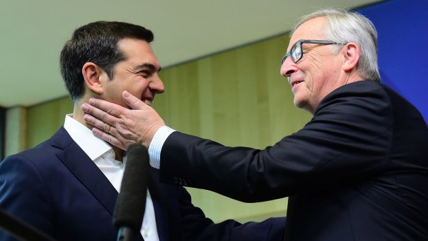 Greece's Prime Minister Alexis Tsipras (left) is welcomed by European Commission President Jean-Claude Juncker ahead of an emergency leader's summit in Brussels.