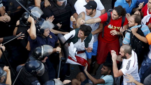 Lebanese riot policemen clash with protesters in Beirut.