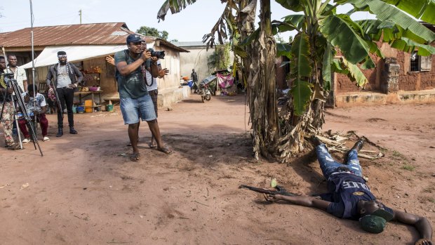 An actor plays a policeman slain in a shootout during filming in Nigeria.