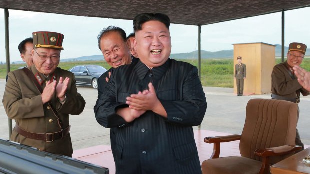 North Korean leader Kim Jong-un, centre, celebrates his latest missile test launch on Friday. Independent journalists were not given access.