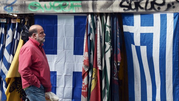Greek flags for sale in Athens. The government is due to present a list of reforms at a crunch meeting of the Eurogroup in Brussels.