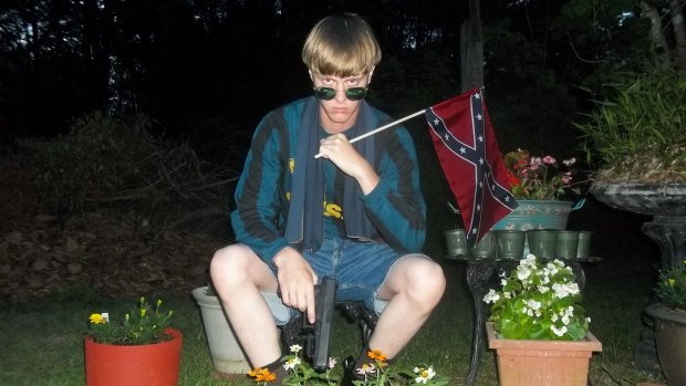 Alleged shooter ... This photo allegedly showing Dylann Roof was found on a website with a white supremacist manifesto and dozens of photographs of the alleged Charleston shooter holding weapons, burning an American flag and visiting historic sites in the US South.