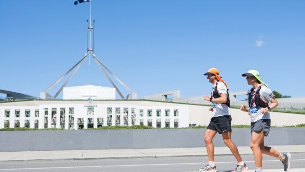 Jackson Bursill and Cassie Cohen arrive at Parliament House in Canberra during their run from Cooktown, Queensland to Melbourne, Victoria. 