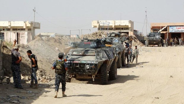 Iraqi security forces, backed by Sunni and Shiite volunteers clash with Islamic State group militants at the front line in the eastern suburbs of Ramadi, Anbar province, Iraq, late last month.