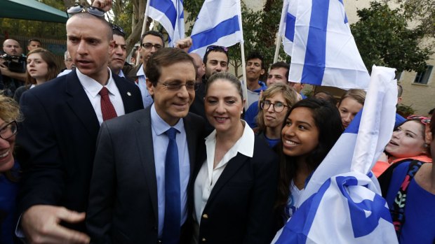 Main contender ... Isaac Herzog (second from left), co-leader of the centre-left Zionist Union party, stands with his wife, Michal, after casting their ballot at a polling station in Tel Aviv.