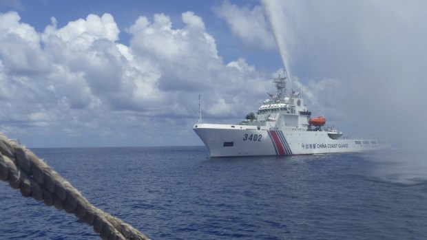 A China Coast Guard vessel approaches Filipino fishermen  off Scarborough Shoal in the South China Sea in September 2015.