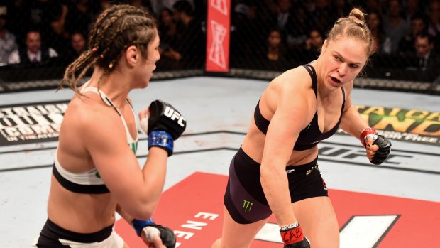 Ragin' cagin': Ronda Rousey (right) of the United States throws a punch at Bethe Correia of Brazil in their UFC women's bantamweight championship bout during the UFC 190 event in Rio de Janeiro.  