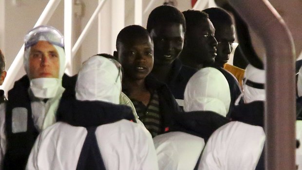 Surviving immigrants arrive by Italian coastguard ship Bruno Gregoretti in Catania's Harbour.