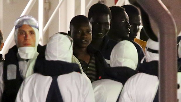 Surviving immigrants arrive by Italian coastguard ship Bruno Gregoretti in Catania's Harbour.