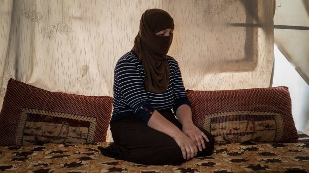 A Yazidi woman who had been held by Islamic State militants as a slave for several months sits in a tent outside Duhok, Iraq. 