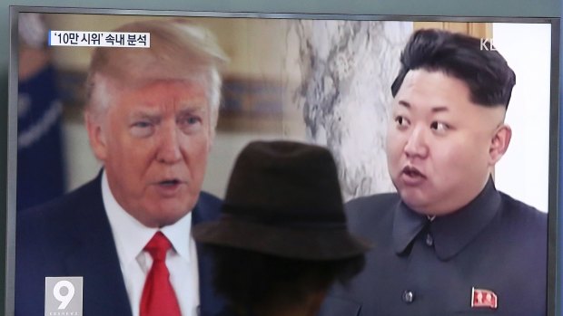 A man watches a television screen showing US President Donald Trump and North Korean leader Kim Jong-un, in South Korea.