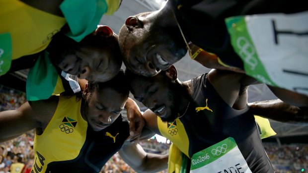 A moment of reflection: Usain Bolt celebrates with teammates Asafa Powell, Yohan Blake and Nickel Ashmeade.
