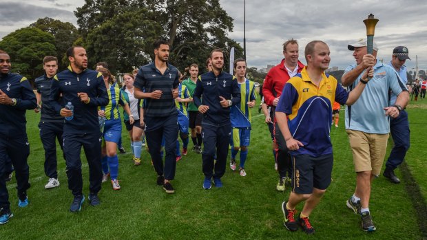 Meeting the stars: Andros Townsend (carrying water bottle) and other Tottenham Hotspur players conducted a coaching clinic at Birchgrove Oval with players from the Special Olympics football team.