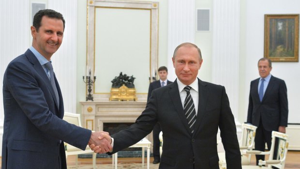 Russian President Vladimir Putin shakes hand with Syrian President Bashar Assad in Moscow in October 2015. 