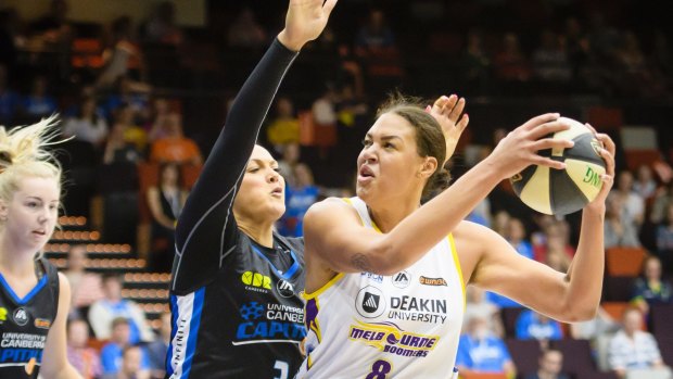 Capitals forward Mistie Bass tries to defend against Boomers centre Liz Cambage.