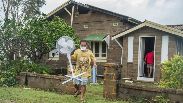 Bowen resident Joel Medil empties his cyclone-damaged home. 