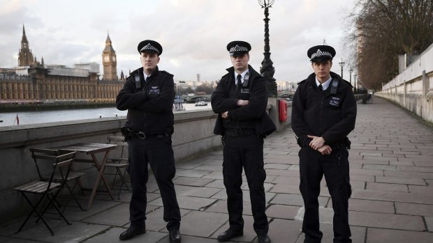 Police officers block access to the southern entrance of Westminster Bridge after the attack. 