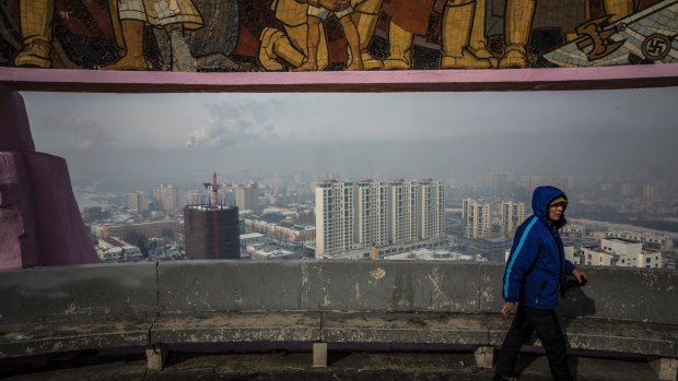 The rising skyline framed by a Soviet-era monument in Ulaanbaatar, Mongolia.