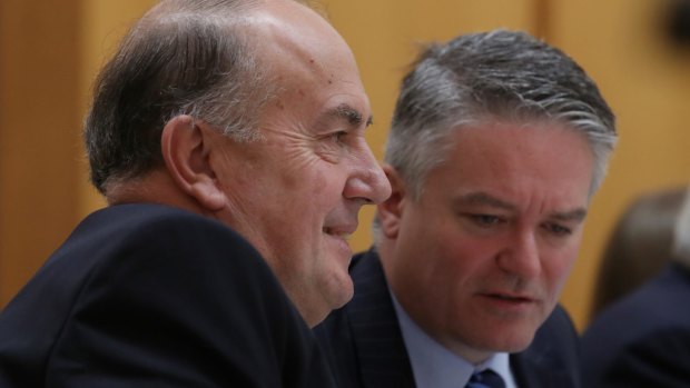 Treasury head John Fraser with Finance Minister Mathias Cormann during estimates hearings. An excellent rationale for the levy is to fund the implied guarantee that the governments gives to the big banks, yet Fraser says that's not the tax's purpose.