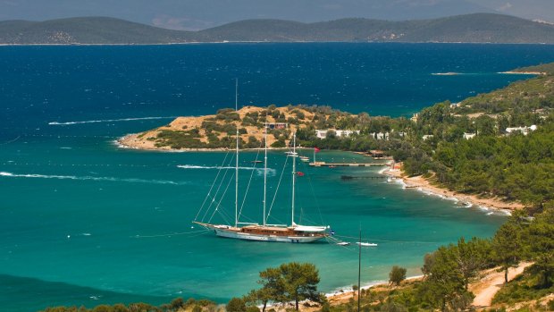 A gulet (traditional Turkish wooden sailing vessel) moors in scenic Bodrum.