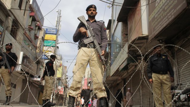 A Pakistani police officer standing guard in Lahore last week. Feared Lashkar-i-Jhangvi terrorist Haroon Bhatti has been killed during a police operation in the city.